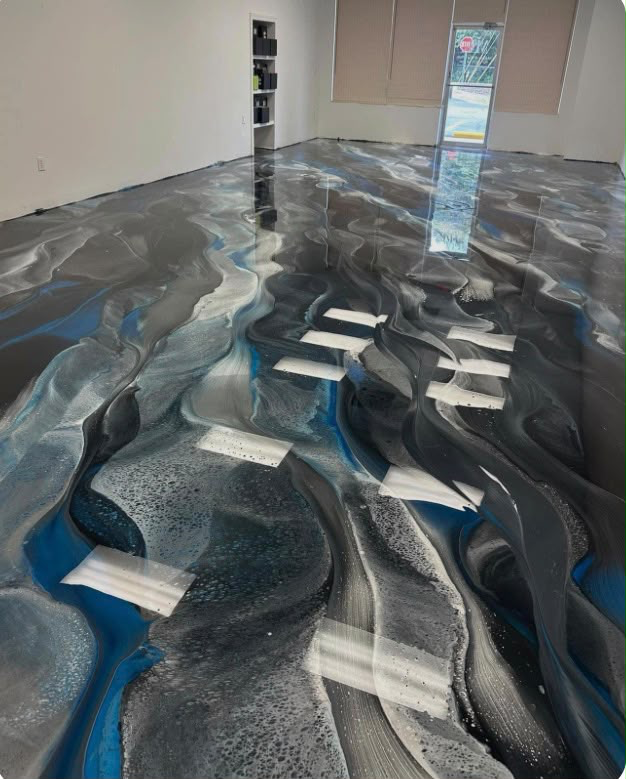 A supplied metallic floor reference with flowing silver, charcoal and blue